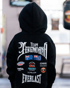 Back of the kids black Team Teremoana Hoodie with the hood up, showing the full back print