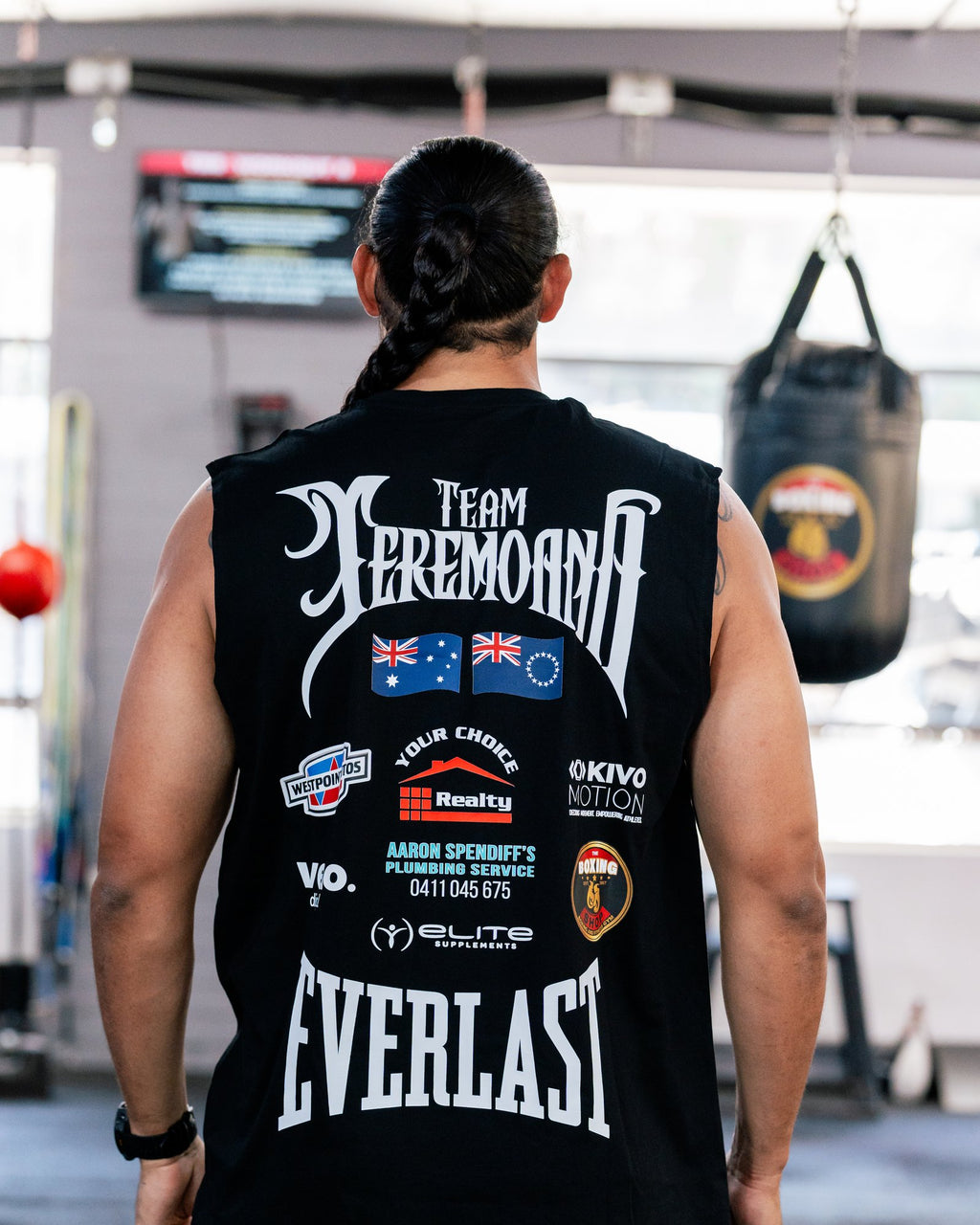 Back of the black Team Teremoana Muscle Tank on Teremoana, showing the team back print