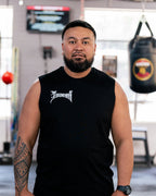 Teremoana wearing the black Team Teremoana Muscle Tank, arms crossed
