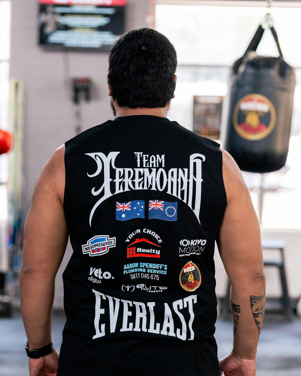 Back view of the black Team Teremoana Muscle Tank with the flags and sponsor print