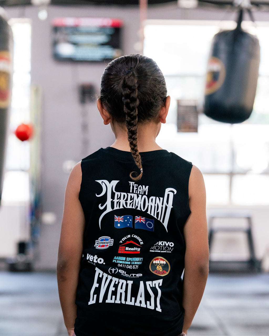Back of the kids black Team Teremoana Muscle Tank showing the full back print