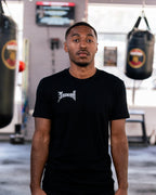 Teremoana wearing the black Team Teremoana Tee in the gym, front view