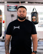 Teremoana in the black Team Teremoana Tee, relaxed front view in the gym
