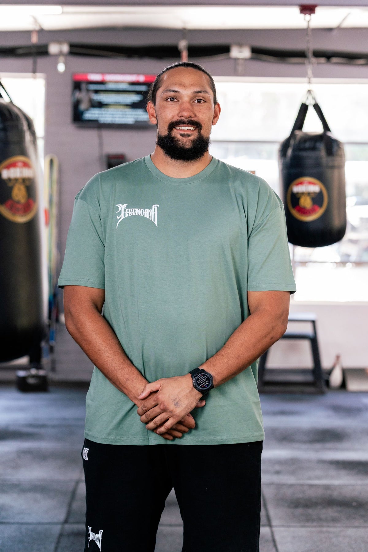 Teremoana wearing the Sage Team Teremoana tee, front view with the wordmark on the chest